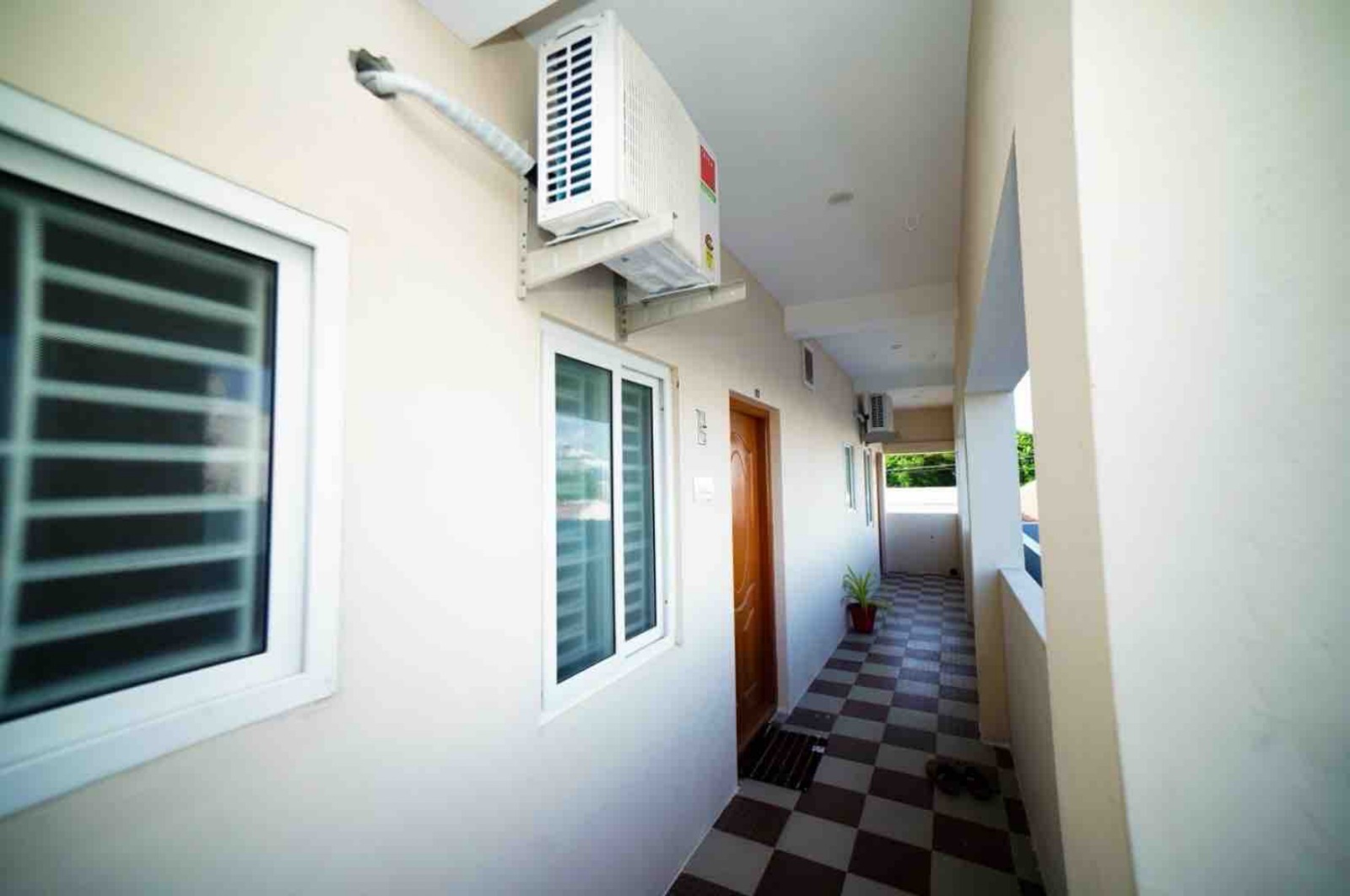 Open balcony corridor with split AC outdoor units